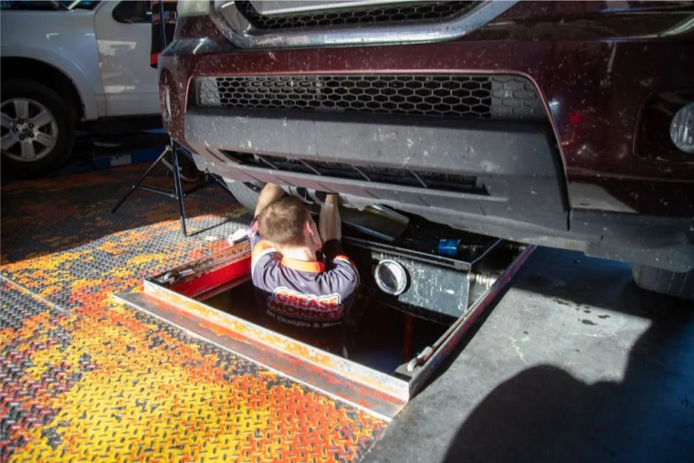 Grease Monkey Mechanic working under a vehicle