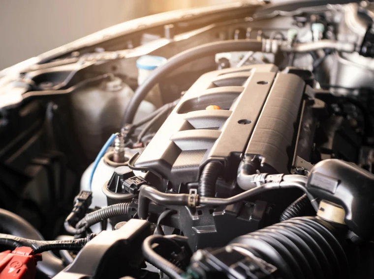 A modern car engine parts and hoses.