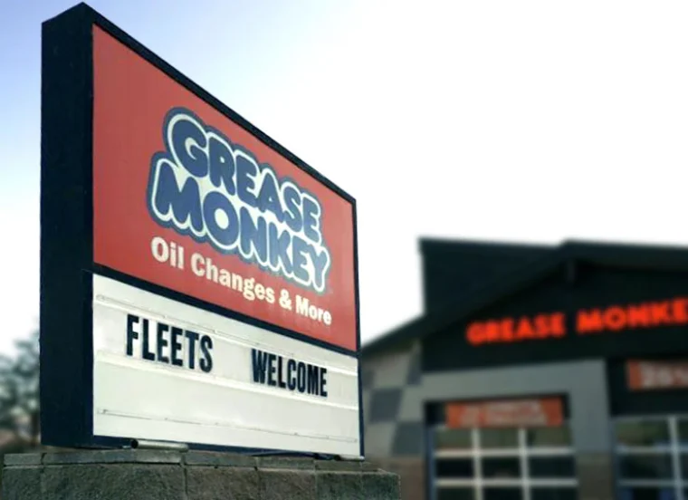 Grease Monkey sign with "Fleets Welcome" text.